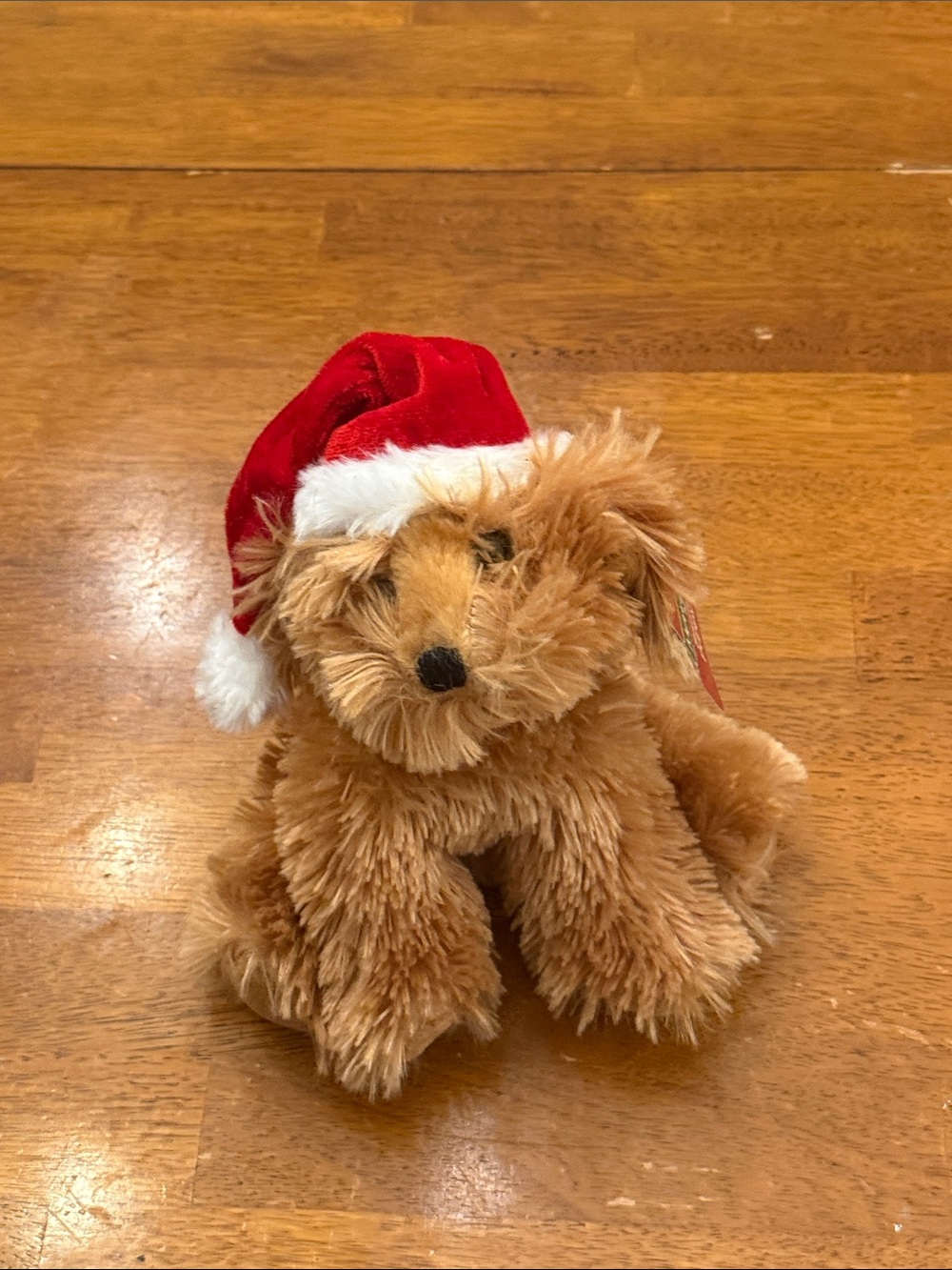 Plush Holiday Dog Figure in Brown and Red Santa Hat